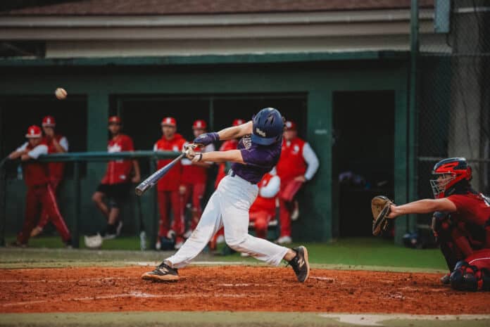 Kaine Ellis (So) of Hernando hits a fly ball and makes it to second base. [Photo by Cynthia Leota]