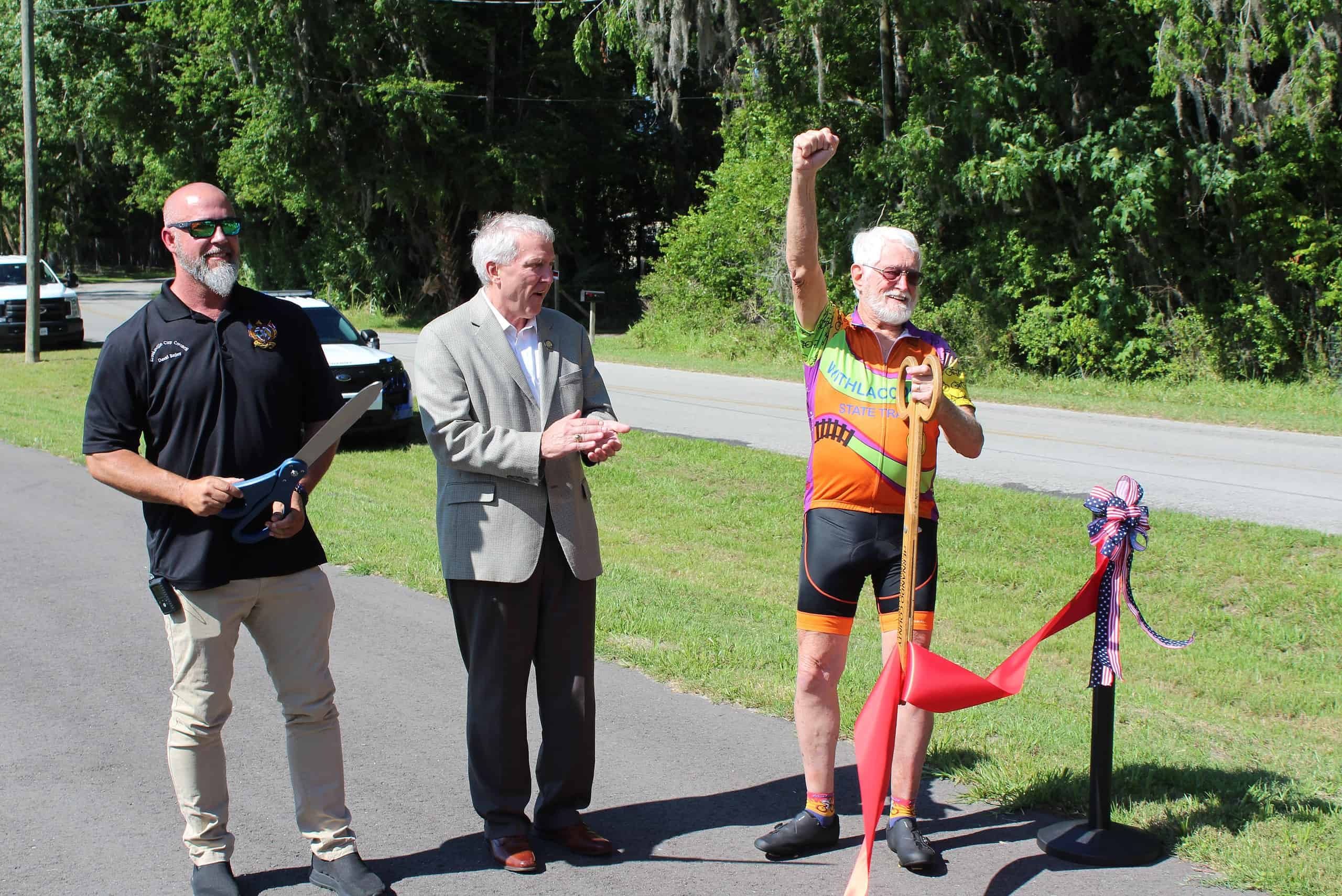 Jim McLean (right) celebrates the cutting of the ribbon and the opening of the Good Neighbor Trail with Brooksville City Council member David Bailey. [Photo by Austyn Szempruch]