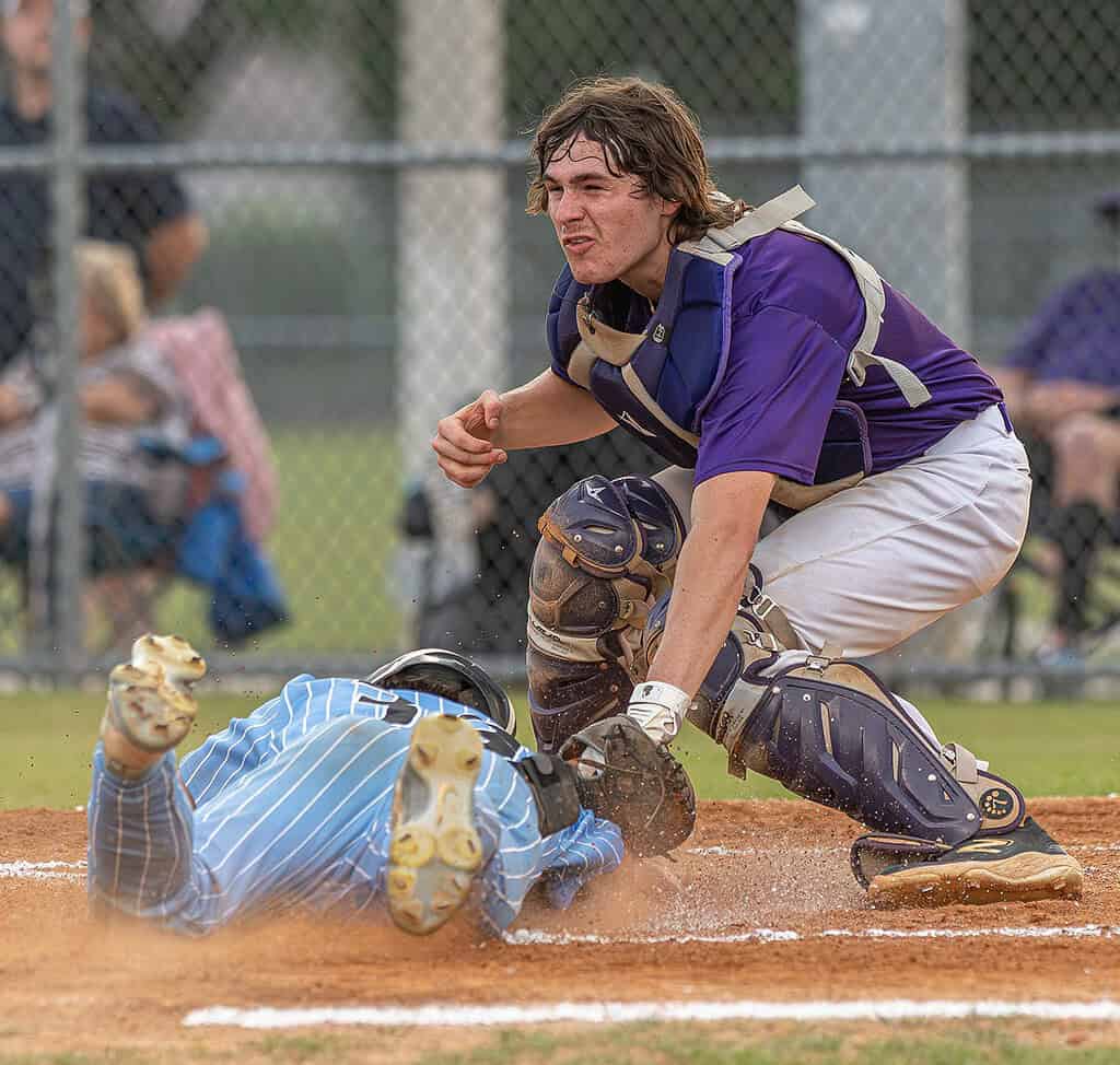 Hernando High School’s catcher, Kaine Ellis, puts the tag on Nature Coast Tech's sliding Cashis Williams in the first inning during the 4A District 6 title game played at NCT. Photo by [Joseph Dicristofalo]