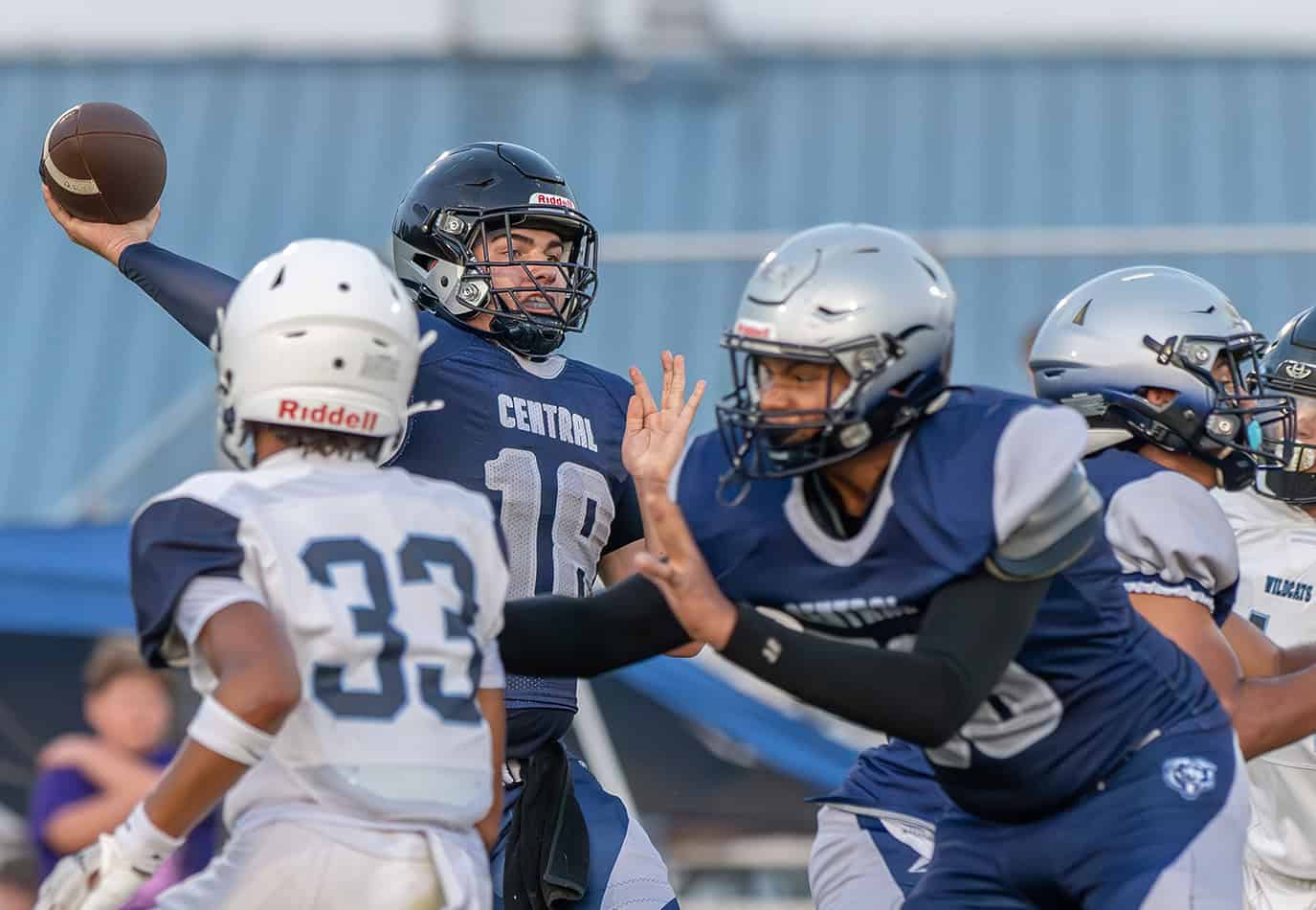 Central High’s QB, 18, Talyn Poole attempts a pass as, 50, Gabriel DeLaPlaz provides blocking in the game with Wesley Chapel Friday at the Bear Den. Photo by [Joseph DiCristofalo]