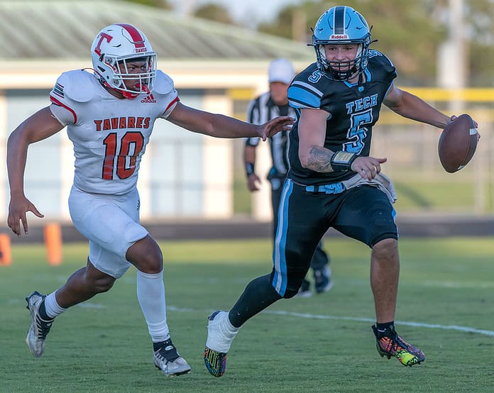 Nature Coast Tech quarterback, 5, Jackson Hoyt scrambles away from a Tavares High defender Friday in Brooksville. Photo by [Joseph DiCristofalo﻿]