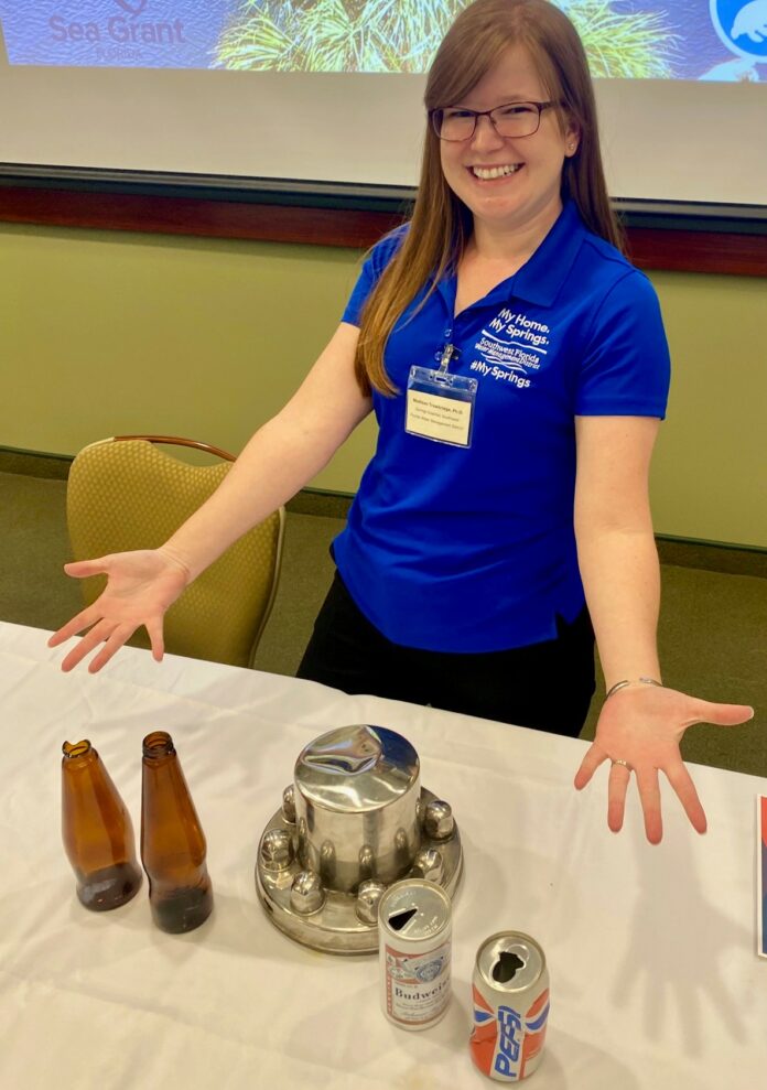 Dr. Madison Trowbridge shows off some of the dredging finds at the Weeki Wachee River Summit on May 3. [Courtesy of SWFWMD]