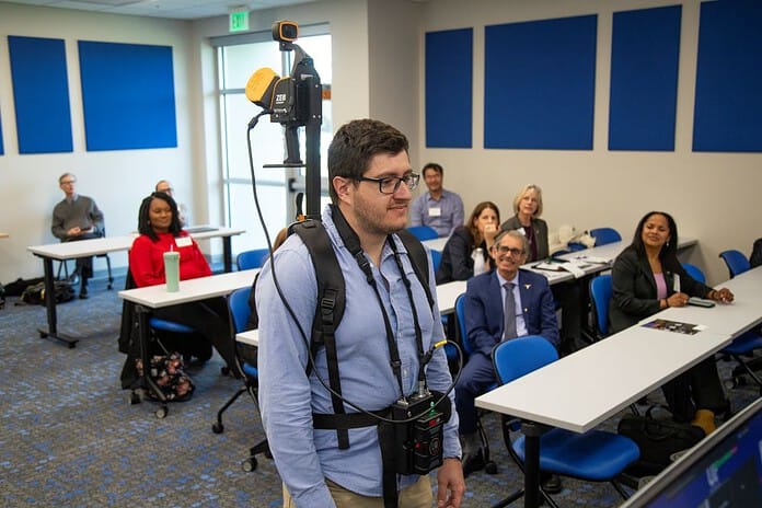 A student shows off UF/IFAS researcher Carlos Silva's lidar backpack. [Photo Credit: UF/IFAS]