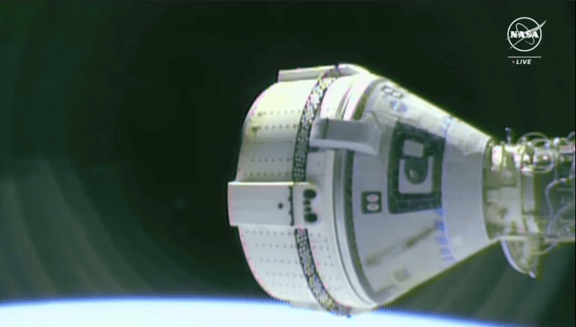 The Boeing Starliner remains docked at the ISS at least until June 22, as engineers continue to sort out problems with the thruster system. [Photo by NASA TV]