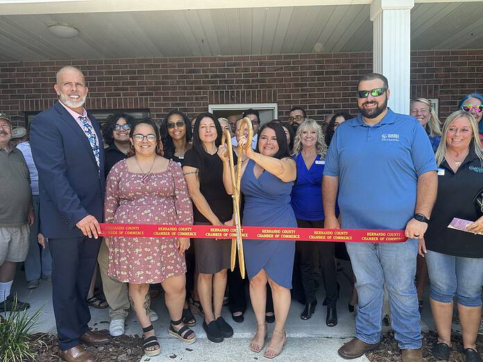 Tina Kinneyand Chad Perdue with NAMI staff cutting the opening ribbon for the recovery wellness center. [Photo by Summer Hampton]