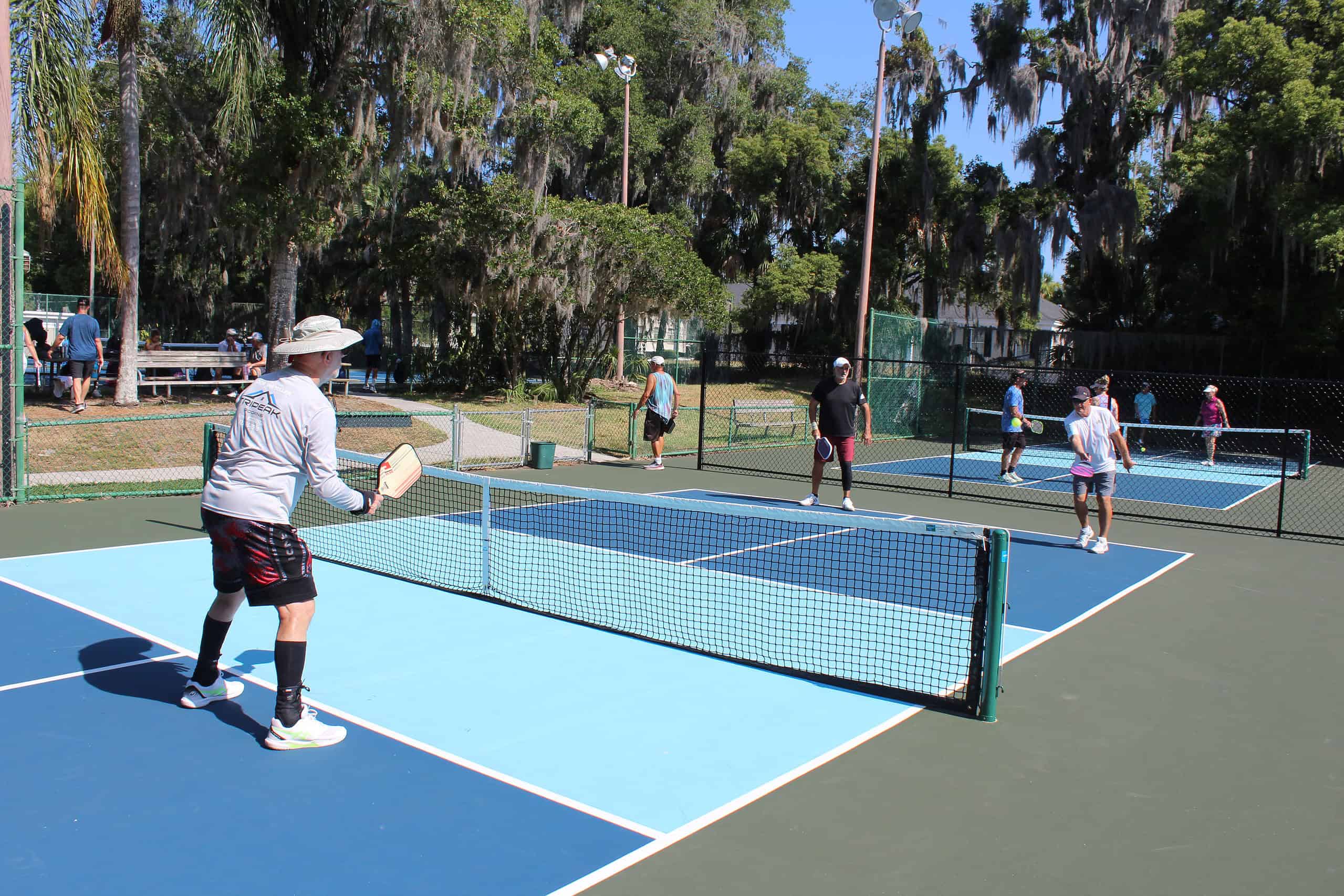 Martin Ratcliffe (left), Nick Pingitore (middle), and Paul Caesar (right) practice pickleball at the courts by the Hernando Library. [Photo by Austyn Szempruch]