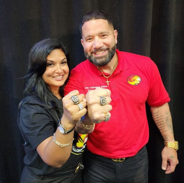 Cristina (left) and Jose Alonzo (right) celebrate their Hall of Fame rings after the induction ceremony on Sunday. [Photo by Austyn Szempruch]