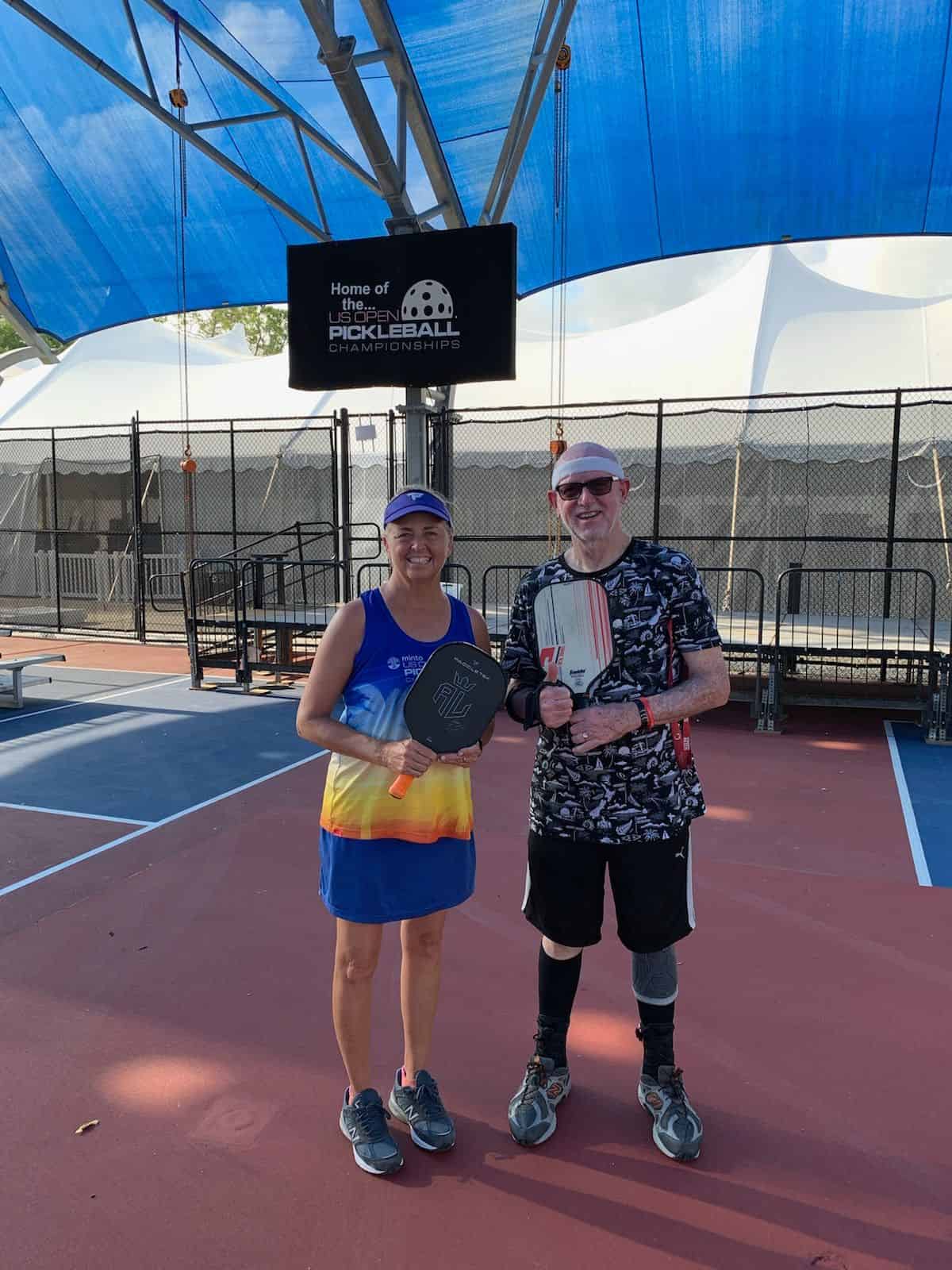 IPTPA instructor Stephanie Lane (left) with local pickleball coach Martin Ratcliffe (right) at the USA Open Pickleball courts in Naples, Florida. [Photo by Shirley Ratcliffe]