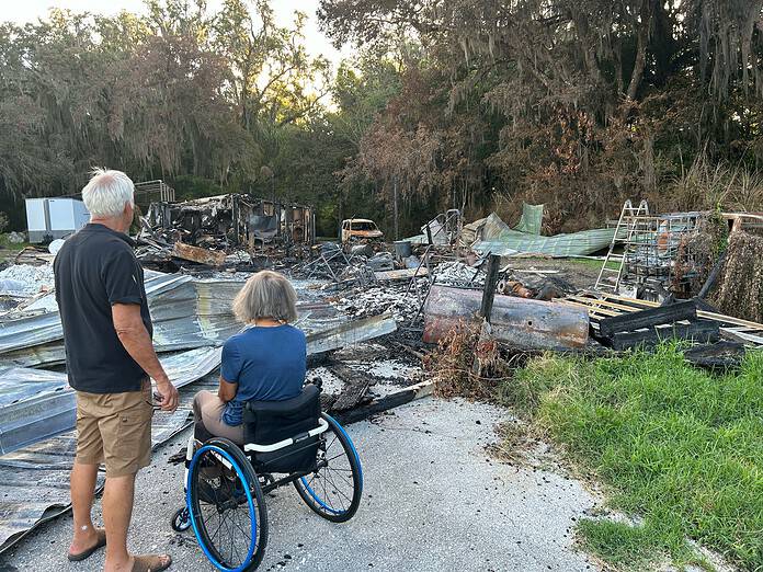 Garry and Becky James survey the remains of their home after it burned down on June 15. [Courtesy photo]