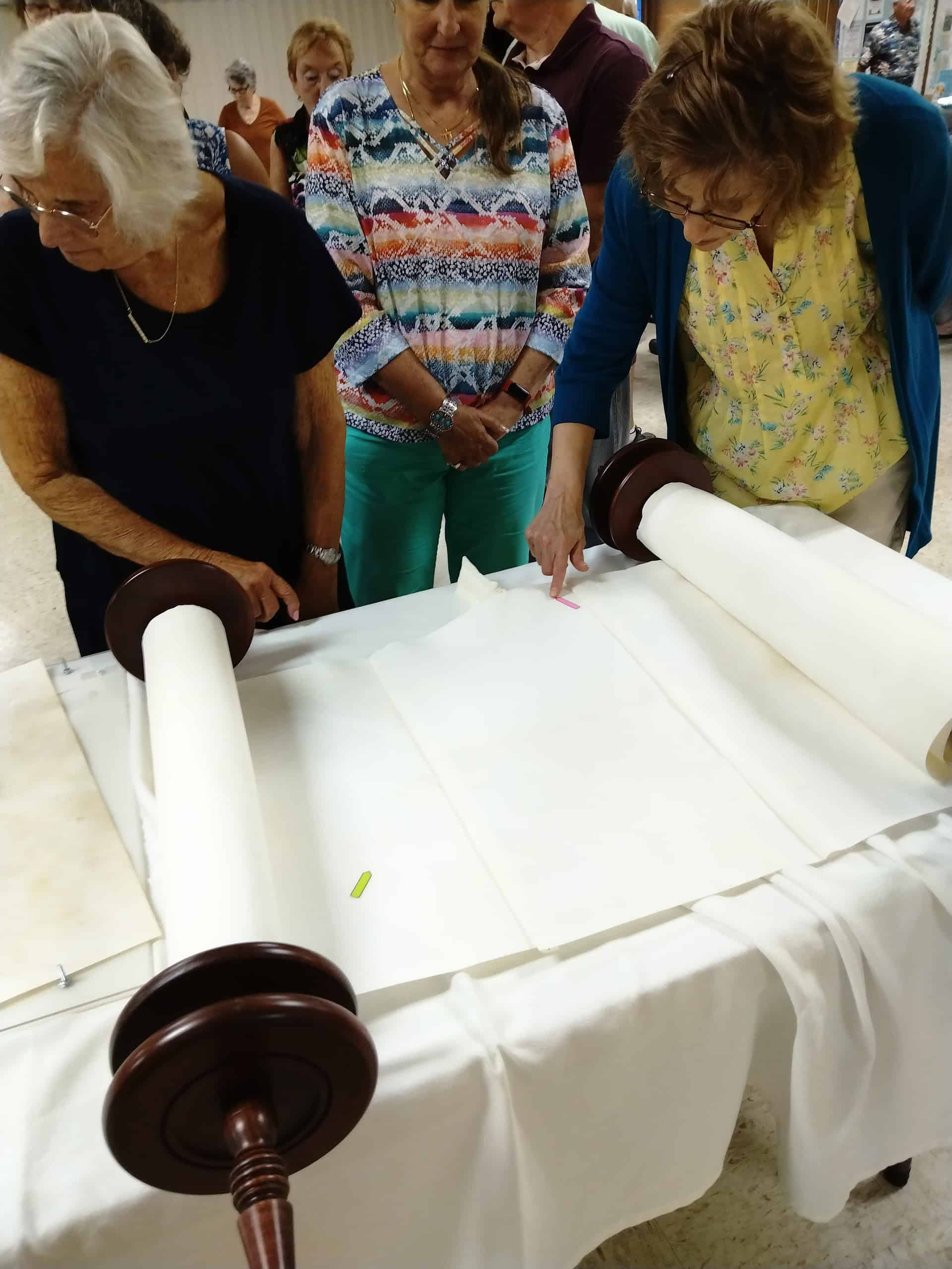 Temple Beth David members examine the Braille Torah. [Courtesy photo]