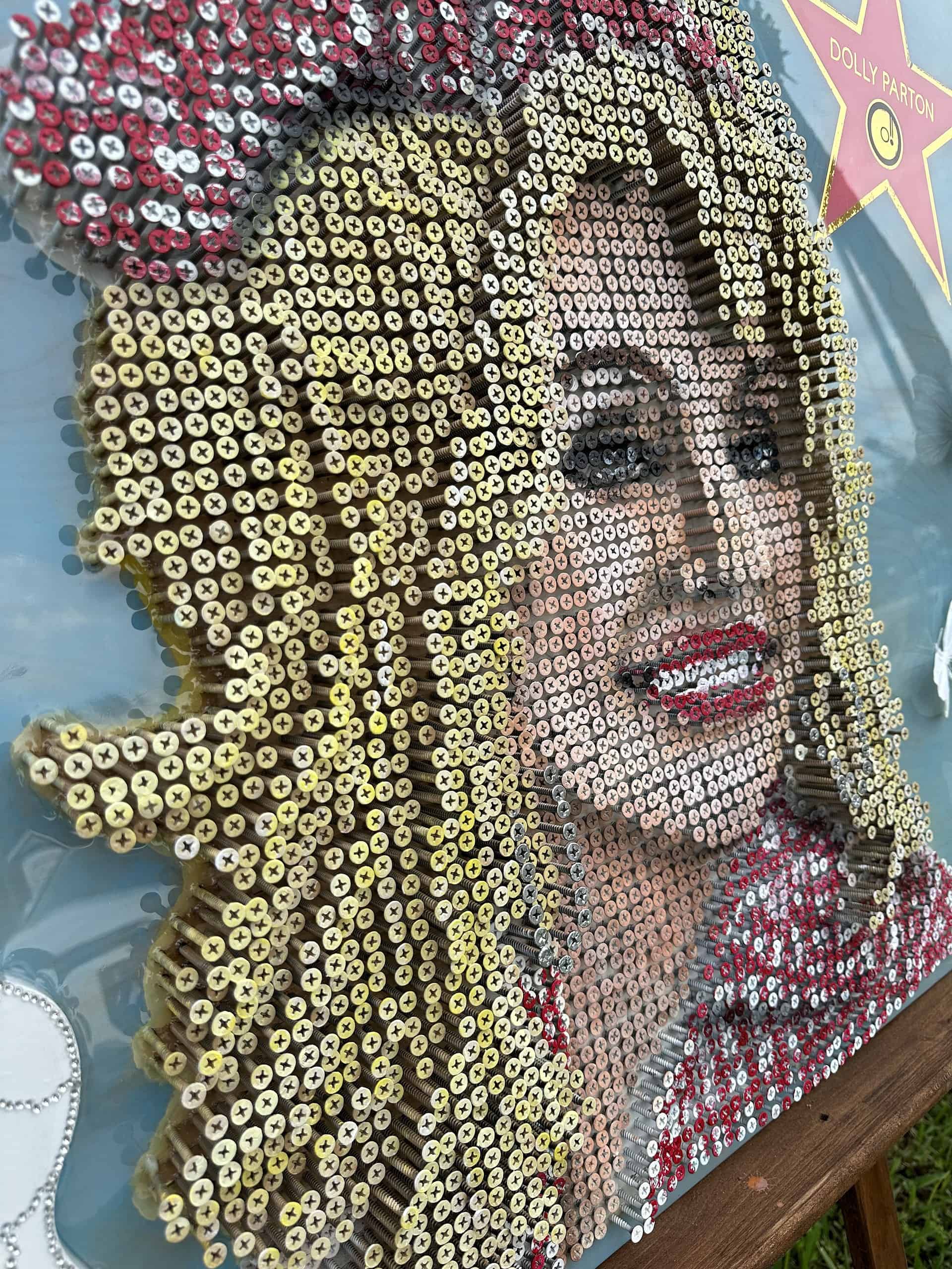 Close up of Dolly Parton screw-art piece.