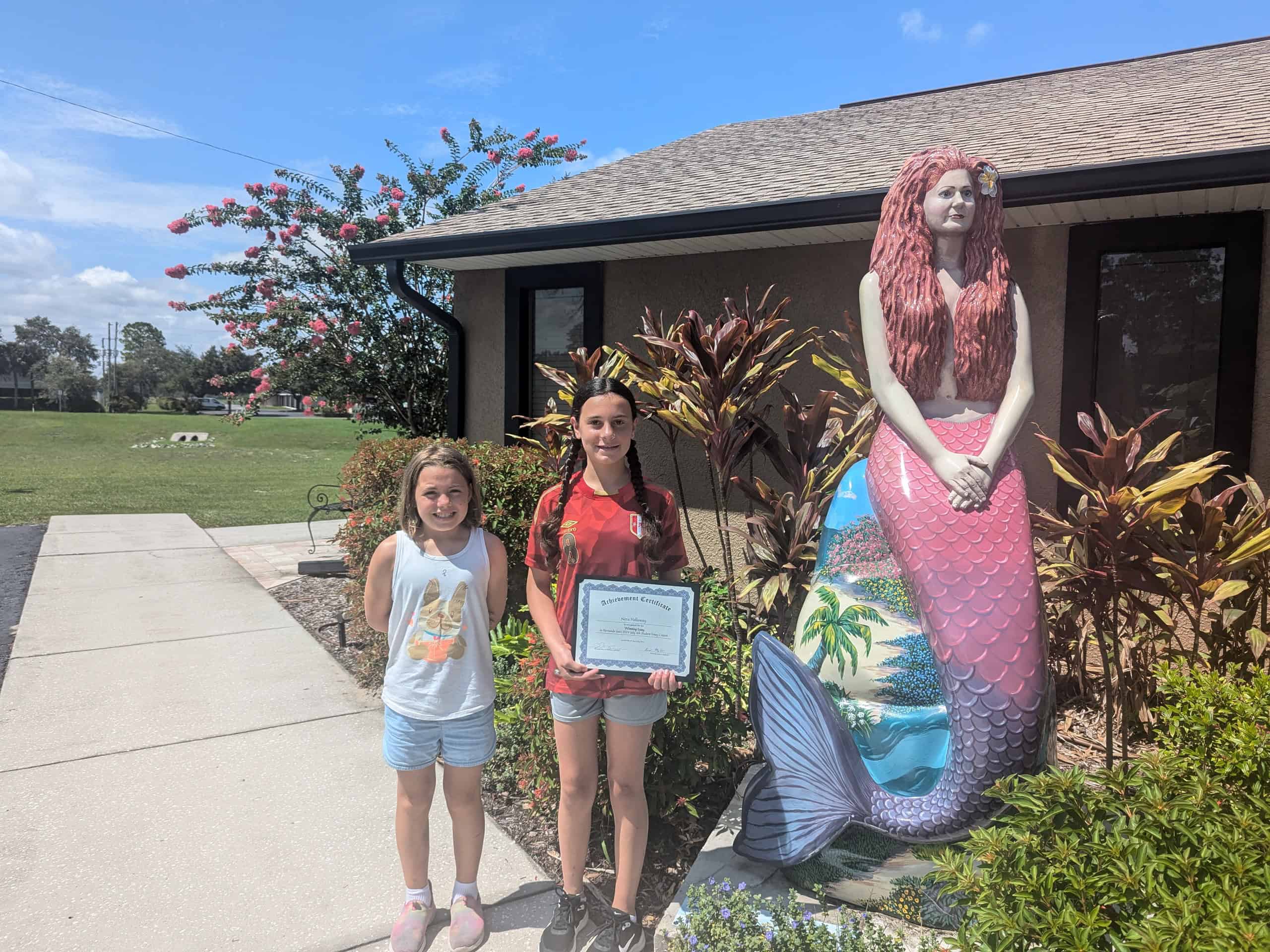 Winner Nora Holloway, age 12, right, with her sister Ellie, age 10.  Nora won for her entry, "The Dream."  We also loved Ellie's submission, "The Book."