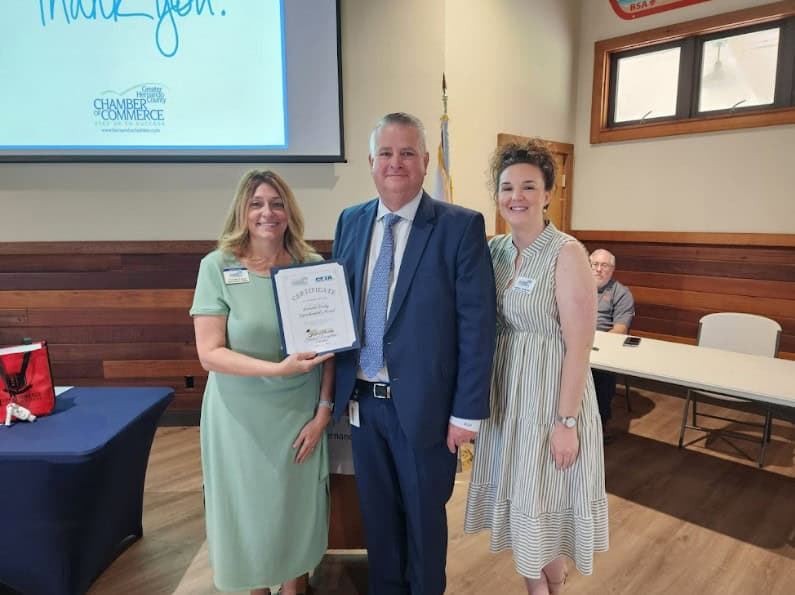 Hernando County Chamber of Commerce members Jennifer Lopez (left) and Ashley Hofecker (right) present a certificate of appreciation to newly minted Superintendent Ray Pinder. [Photo by Austyn Szempruch]