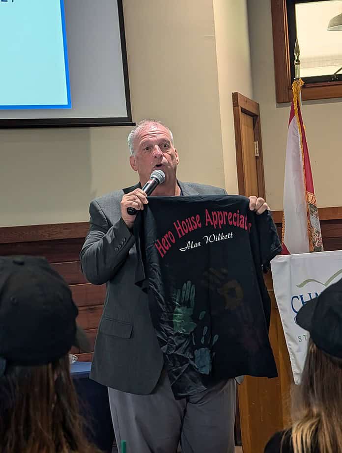 Alan Wilkett shows the shirt given to him by boys who experienced human trafficking