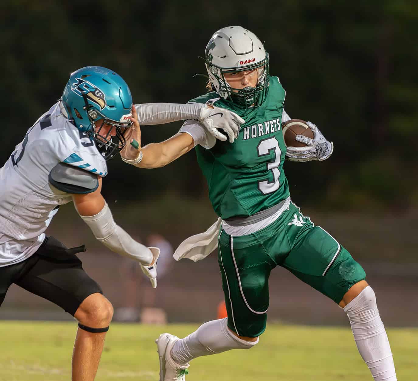 Weeki Wachee QB, 3, Richard Hanshaw use a stiff arm to avoid a tackle versus Sunlake. [Photo by JOE DiCRISTOFALO]