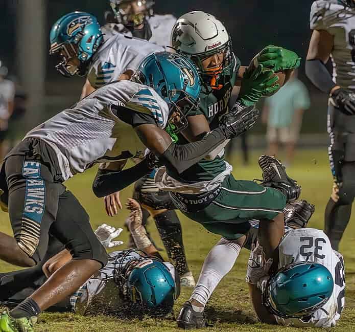 Weeki Wachee Running Back, 5, Joshia Davis had this hard tackle near the goal line remove him from the ball which was recovered in the end zone by Michael Schmidt resulting in a touchdown for the Hornets. [Photo by JOE DiCRISTOFALO]