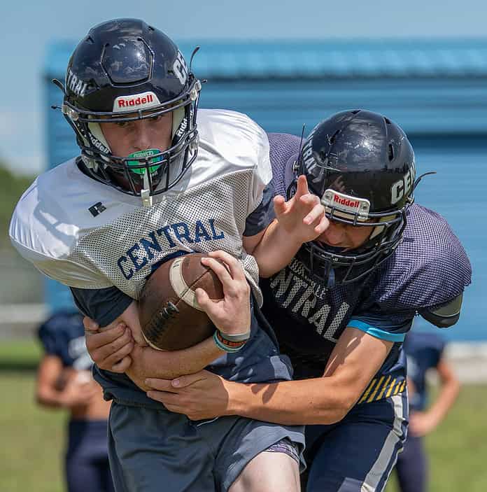 Central High's Jonathan Bunyon and Ashton Curtis participate in a tackling drill in practice. [Photo by Joe DiCristofalo]