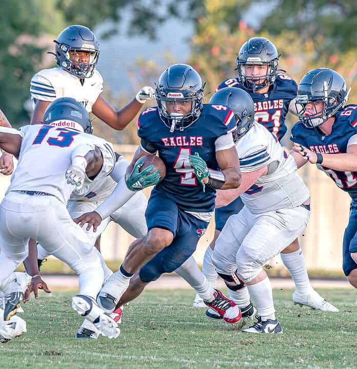 Springstead, 4, Connor McCazzio looks to elude the tackle attempt by Fivay High School, 13, Antwon Brown Friday at Booster Stadium. [Photo by Joseph DiCristofalo]