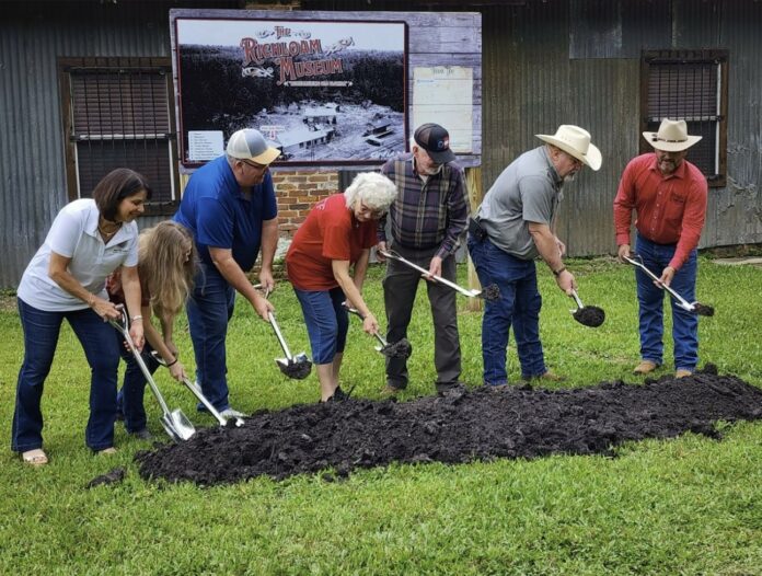 Commissioner Beth Narverud (far left) and Erick Burkes (far right) break ground on the Richloam Museum with family members and directors of Richloam General Store on Saturday. [Photo by Austyn Szempruch]