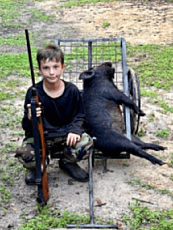 Tanner Criswell and a fine hog he hunted with his grandpa, Dave. [Photo provided by Toby Benoit]