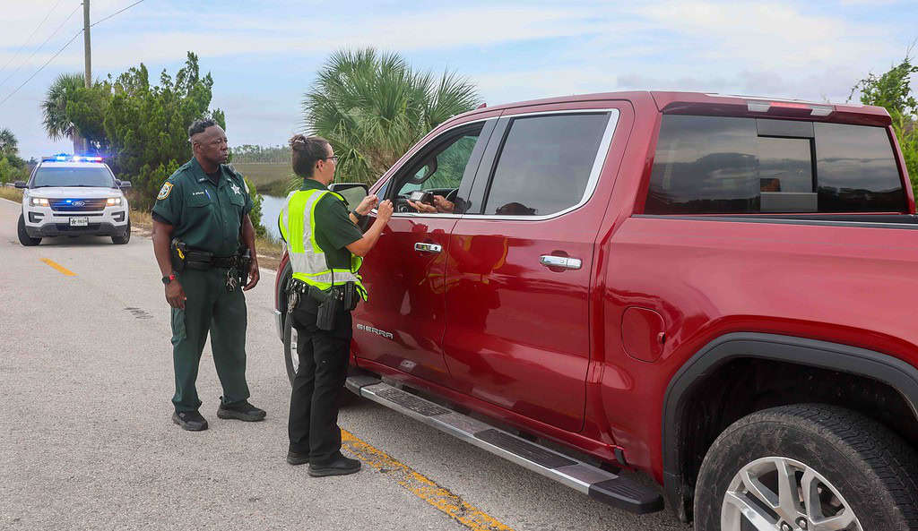 Hernando County Deputies check the identification of persons wanting to drive to Pine Island, allowing only homeowners. [Credit: Mark Stone]