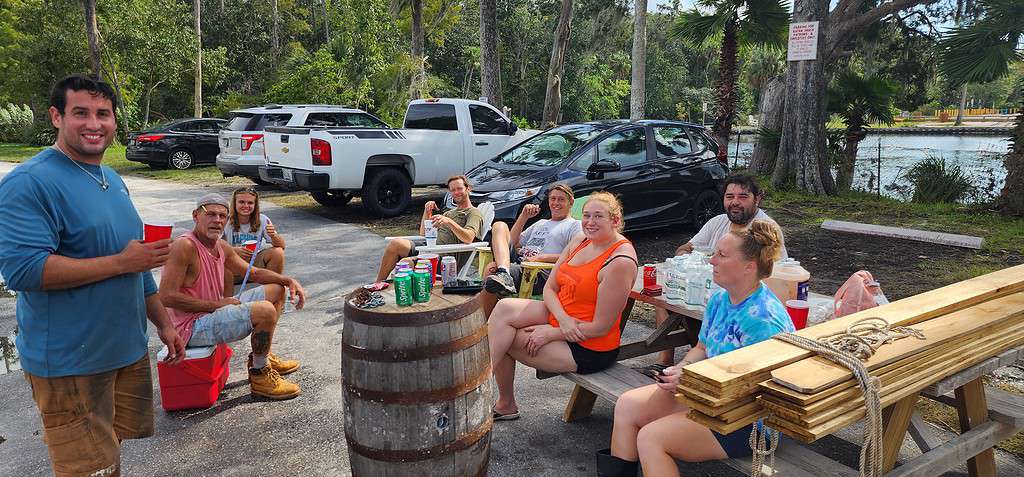 Family and friends take a break from cleaning up debris at the Kayak Shack. [Credit: Mark Stone]