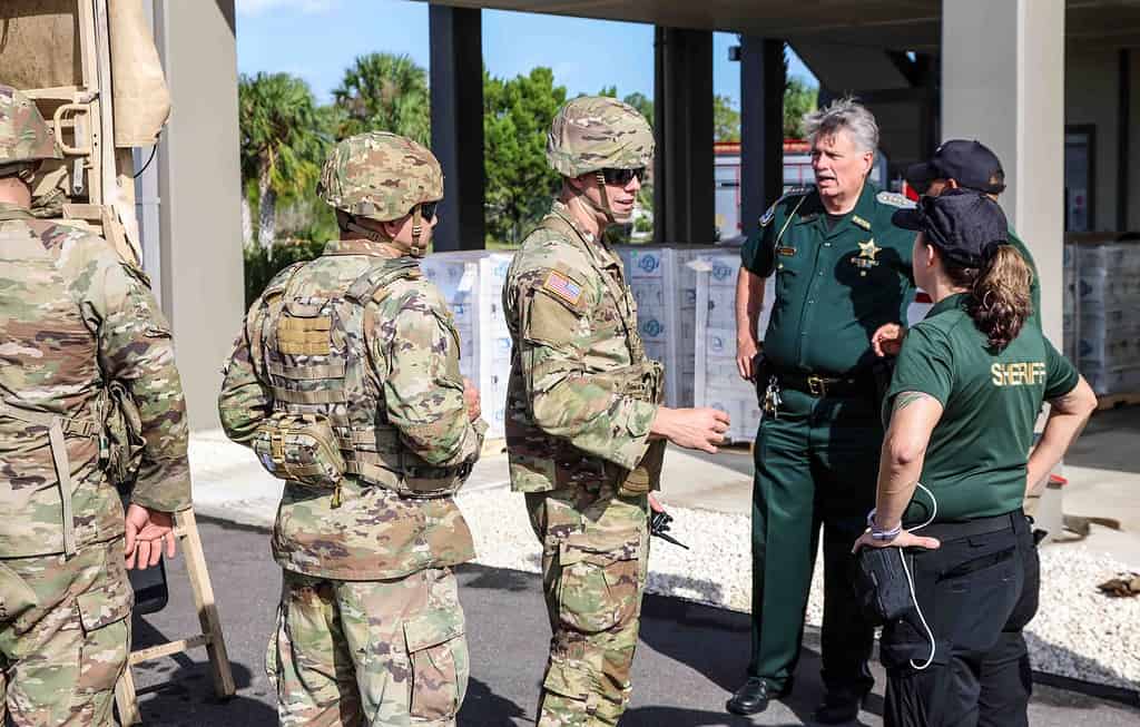 Hernando County Sheriff Al Nienhuis discusses search and rescue plans with deputies and National Guard members. [Credit: Mark Stone]