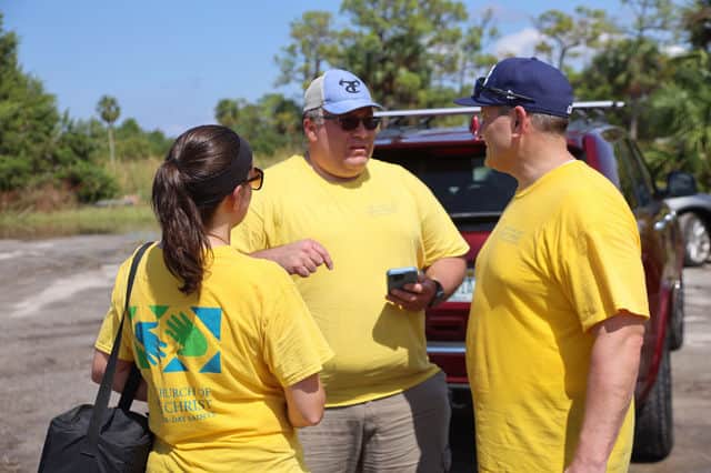 LDS volunteers discuss their cleanup plans. [Credit: Mark Stone]