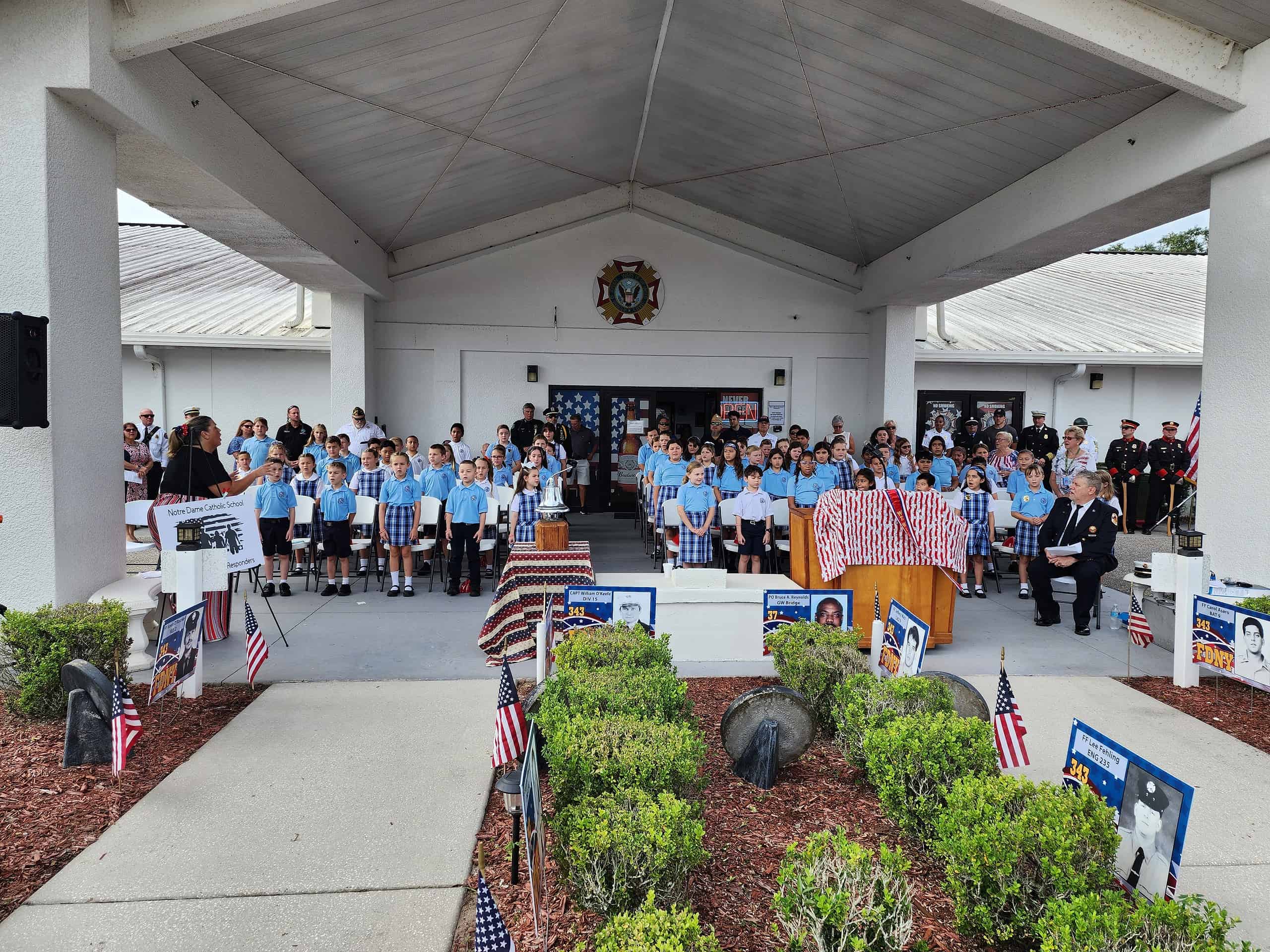 Students from Notre Dame Catholic School sing "Let There Be Peace" at Wednesday's 9/11 remembrance. [Photo by Austyn Szempruch]