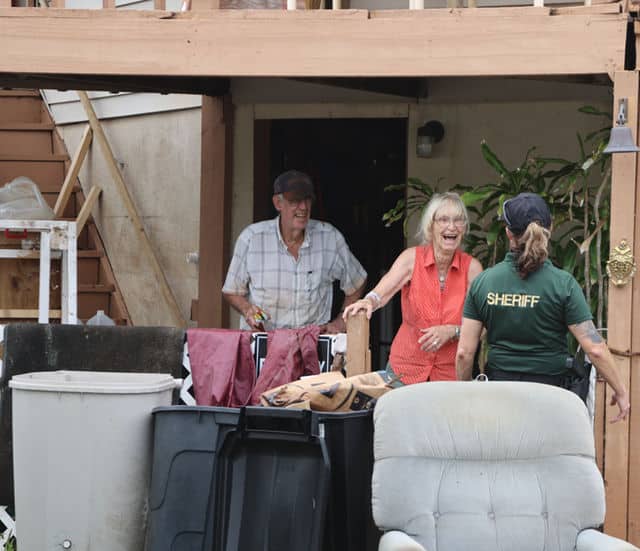 A deputy checks in on two Hernando Beach residents. [Credit: Mark Stone]