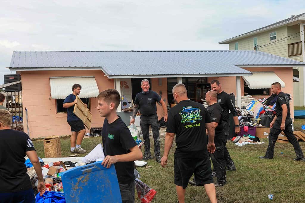 Members of the Florida Highway Patrol pitch in to help with the Hernando Beach cleanup effort. [Credit: Mark Stone]