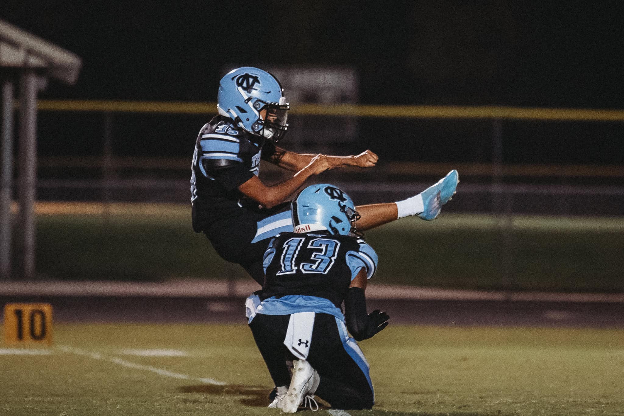 Shark's Kicker, Matthew Chancalay (#35) attempts and extra point. [Photo by Cynthia Leota]