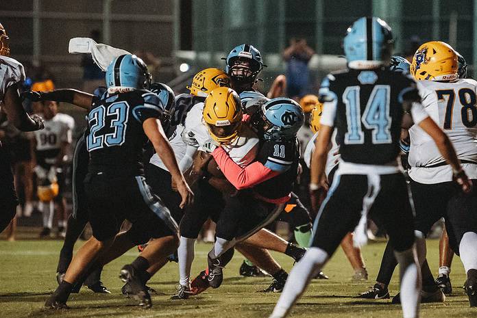 Palatka player taken down by Zaihron Mccullough (#11). [Photo by Cynthia Leota]