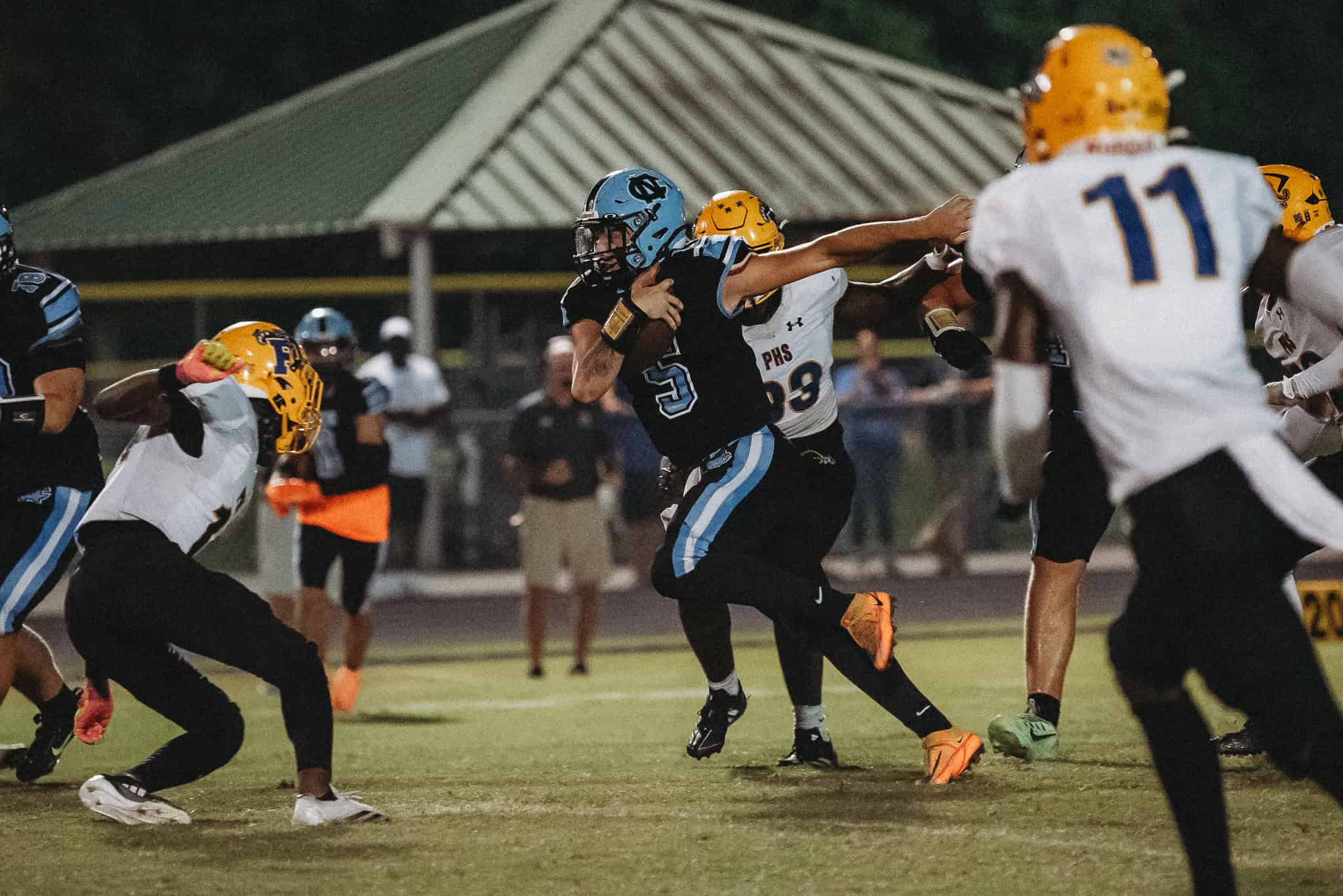 Shark's QB, Jackson Hoyt (#5) rushes against Palatka. [Photo by Cynthia Leota]