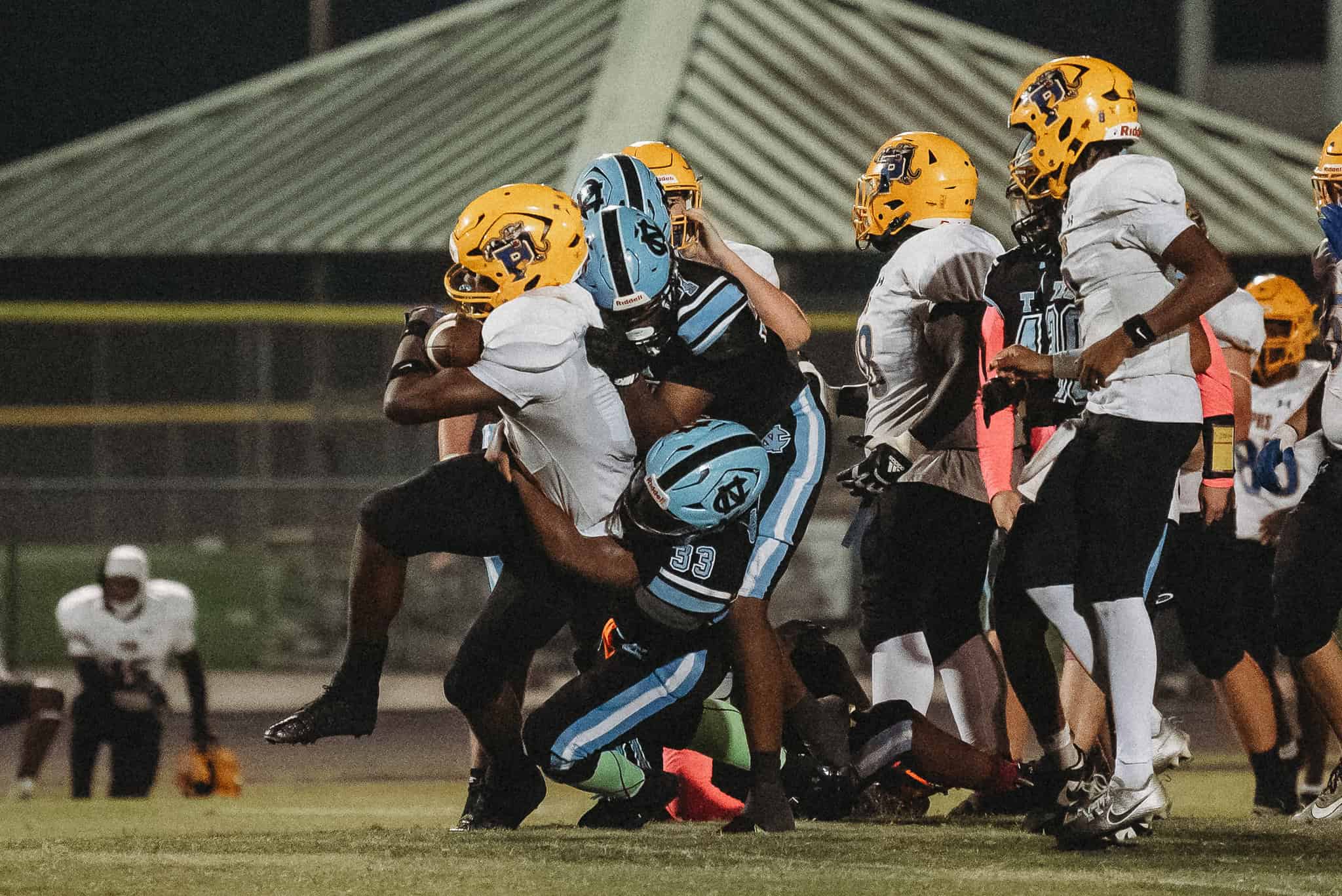 Palatka player taken down by Xavier Mccullough (#33). [Photo by Cynthia Leota]