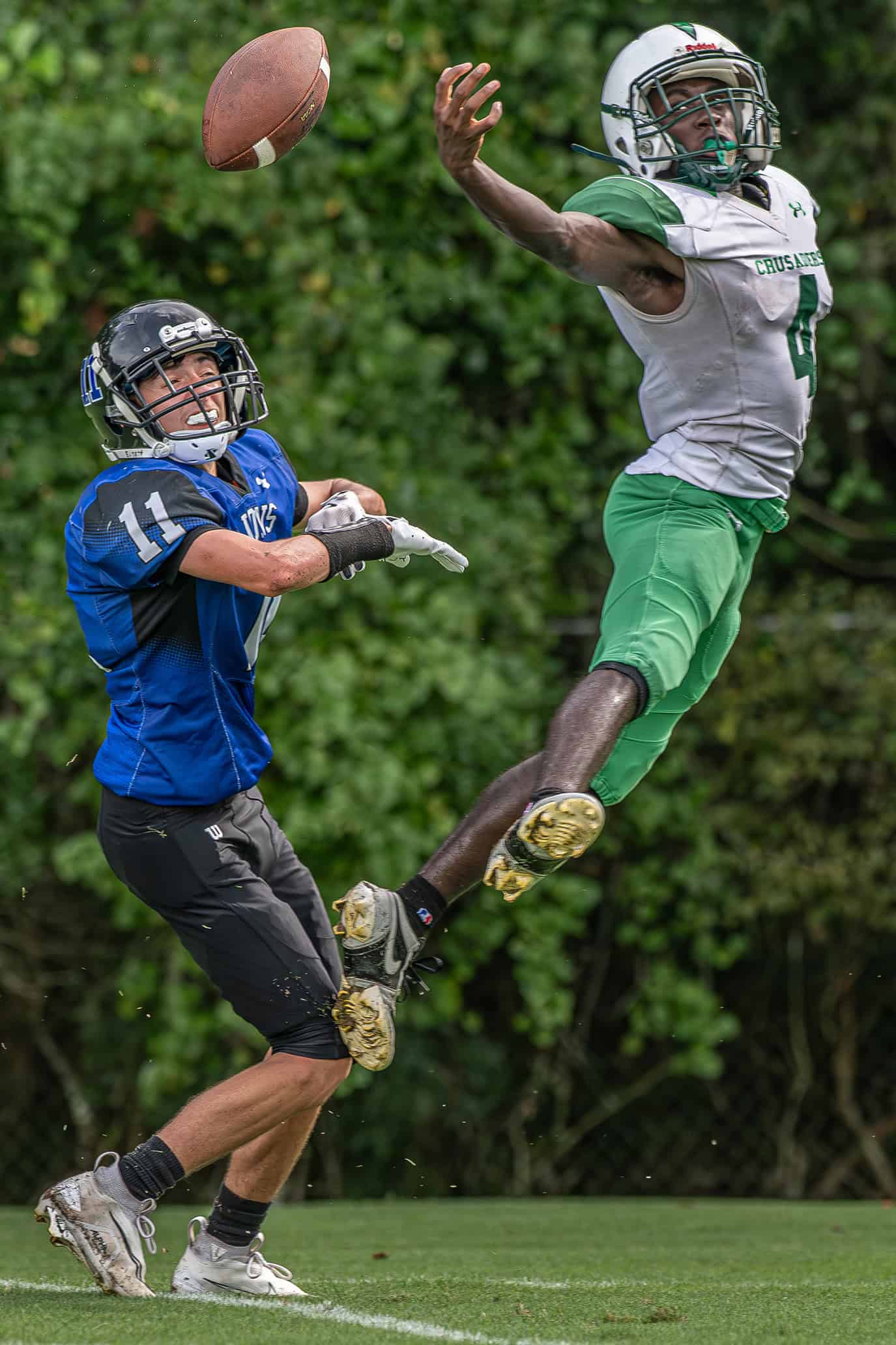 Ocala Christian ,4, Joshua Davis elevated to disrupt a pass intended for Hernando Christian Academy, 11, Camdyn Twardosky Friday afternoon in Brooksville. [Photo by Joe DiCristofalo]