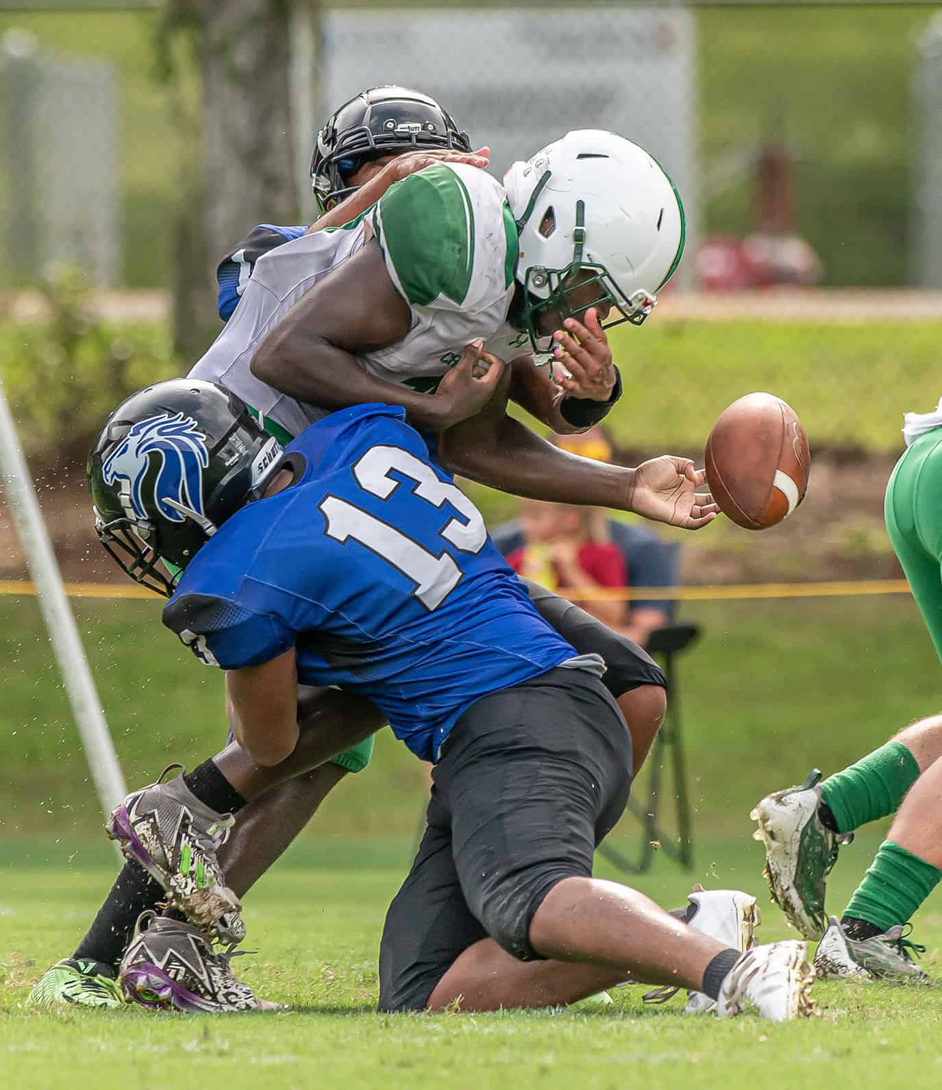 Hernando Christian Academy , 13, Tayvion Howard  seperated the ball fron an Ocala Christian ball carrier Friday afternoon in Brooksville. [Photo by Joe DiCristofalo]