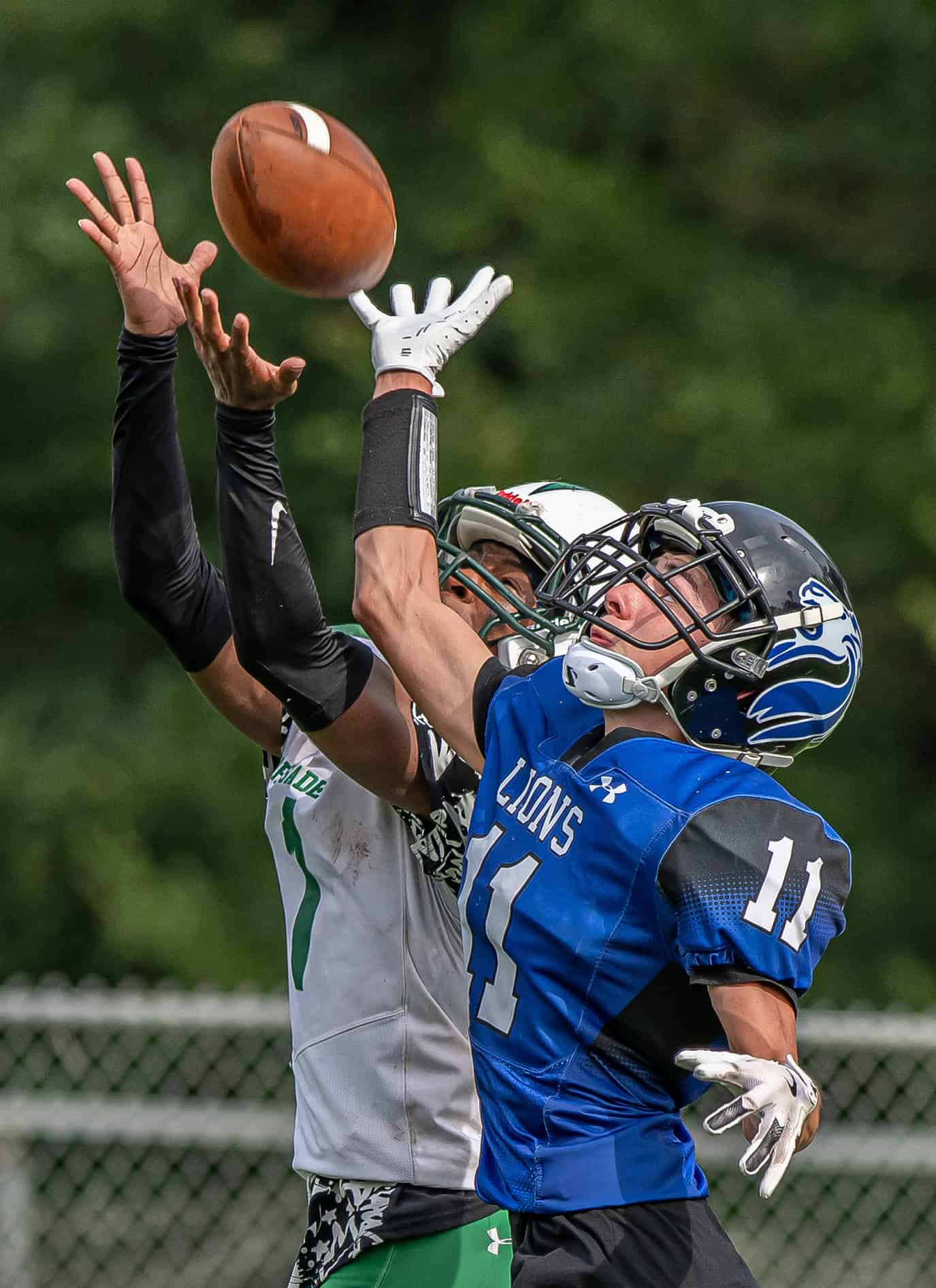 Hernando Christian Academy, 11, Camdyn Twardosky  swats away a pass intended for Ocala Christian ,,1, Brandon Norman Jr Friday afternoon in Brooksville. [Photo by Joe DiCristofalo]