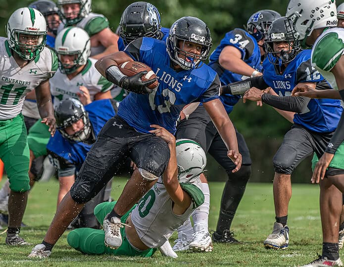 Hernando Christian Academy, 13, Tayvion Howard runs for a gain against the Ocala Christian defense Friday afternoon in Brooksville. [Photo by Joe DiCristofalo]