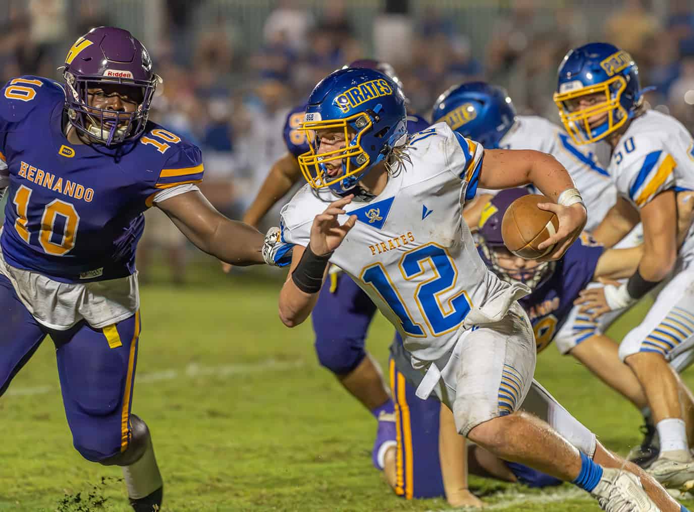 Hernando High, 10, Keaundre Gavin looks to contain Crystal River High Quarterback ,12, Jesse Paul Friday night in Brooksville. [Photo by Joe DiCristofalo]