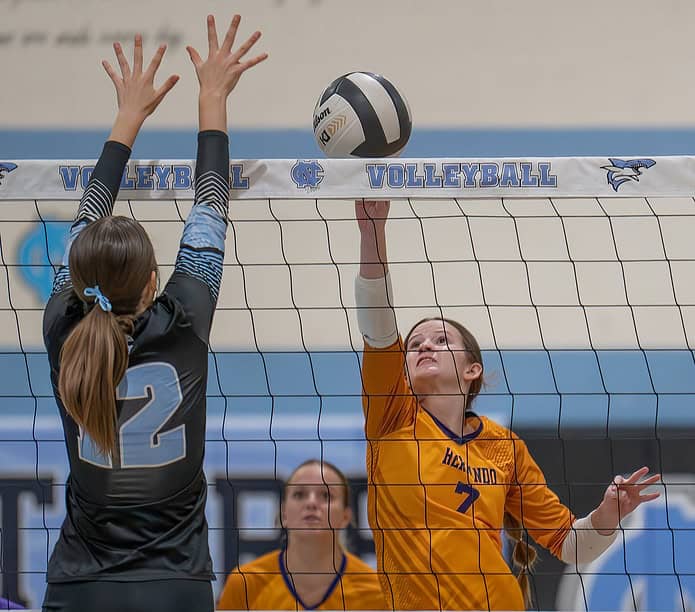 Hernando High, 7, Brooke Hart attempts to volley over Nature Coast Tech, 12, Ava Ferlita Wednesday at NCT. [Photo by Joe DiCristofalo]