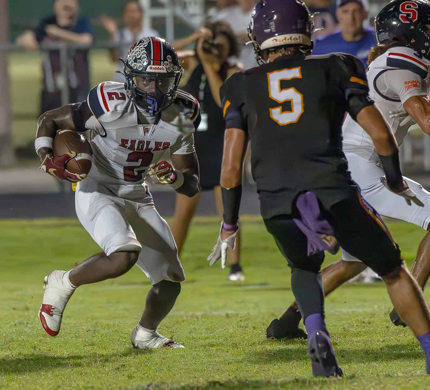 Springstead High running back, 2, Tyree Davis looks to elude a tackle by Hernando High, 5, Sam Jackson in the "Glory Days Burger Bowl Game" Friday versus Hernando High. Photo by [Joseph DiCristofalo]