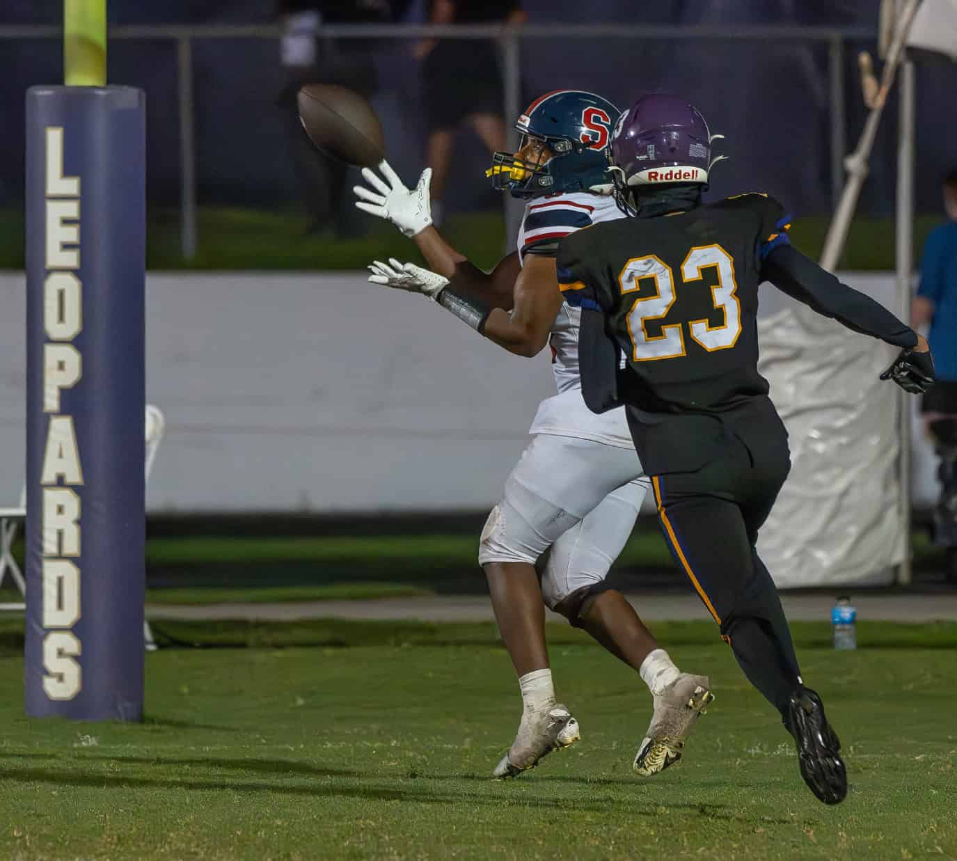 Springstead High, 0, Chadiell Echavarria looks in a touchdown reception behind the defense by Hernando, 23, Michael Brown during the "Glory Days Burger Bowl Game" Friday at Hernando High. [Photo by Joseph DiCristofalo]