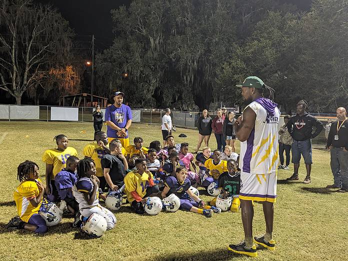 Tyrone Goodson coaching and inspiring the next generation of athletes at a recent football camp. [Credit Rocco Maglio]