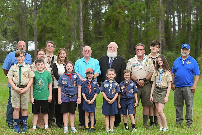 First Row: Left to Right: Henry, Josh, Piper, Scarlett, Amaya, Owen, Sophia; Back Row, Left to Right: George Wentzler- Council Shooting Sports Director; Emily Thomas- District Executive of the Withlacoochee District; Brandon Thomas- Cub Scout Leader; Mariah Delgado, SECO Energy Foundation Executive Director; William Grant- Friends of Scouting Chair for Withlacoochee District (Hernando, Sumter, and Citrus Scouts); Stephen Toner- District Chair for Withlacoochee District; Ernie Lane- Scout Leader; William Thomas- Scout BSA Youth;Ranger Daniel Tremblay- Ranger for Sand Hill Scout Reservation [Courtesy photo]