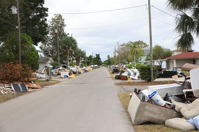 Destroyed property remains piled high outside of Hernando Beach homes on Saturday. [Photo: Mark Stone /FMN]