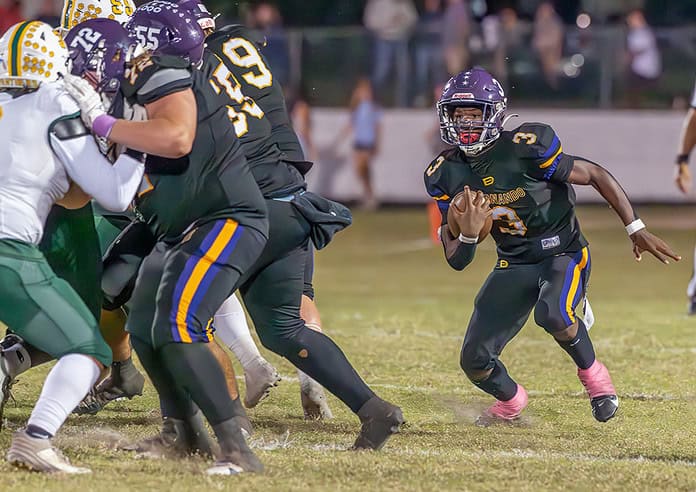 Hernando High running back,3, Jerry Brown follows his blockers for a gain against visiting Lecanto High School during the Leopard's Homecoming game Friday night in Brooksville.[Credit: Joe DiCristofalo]