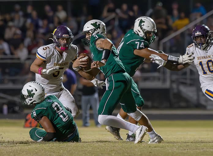 Weeki Wachee High QB, 3, Richard Hanshaw escapes the pocket in the game with visiting Hernando High. [Photo by Joe DiCristofalo]