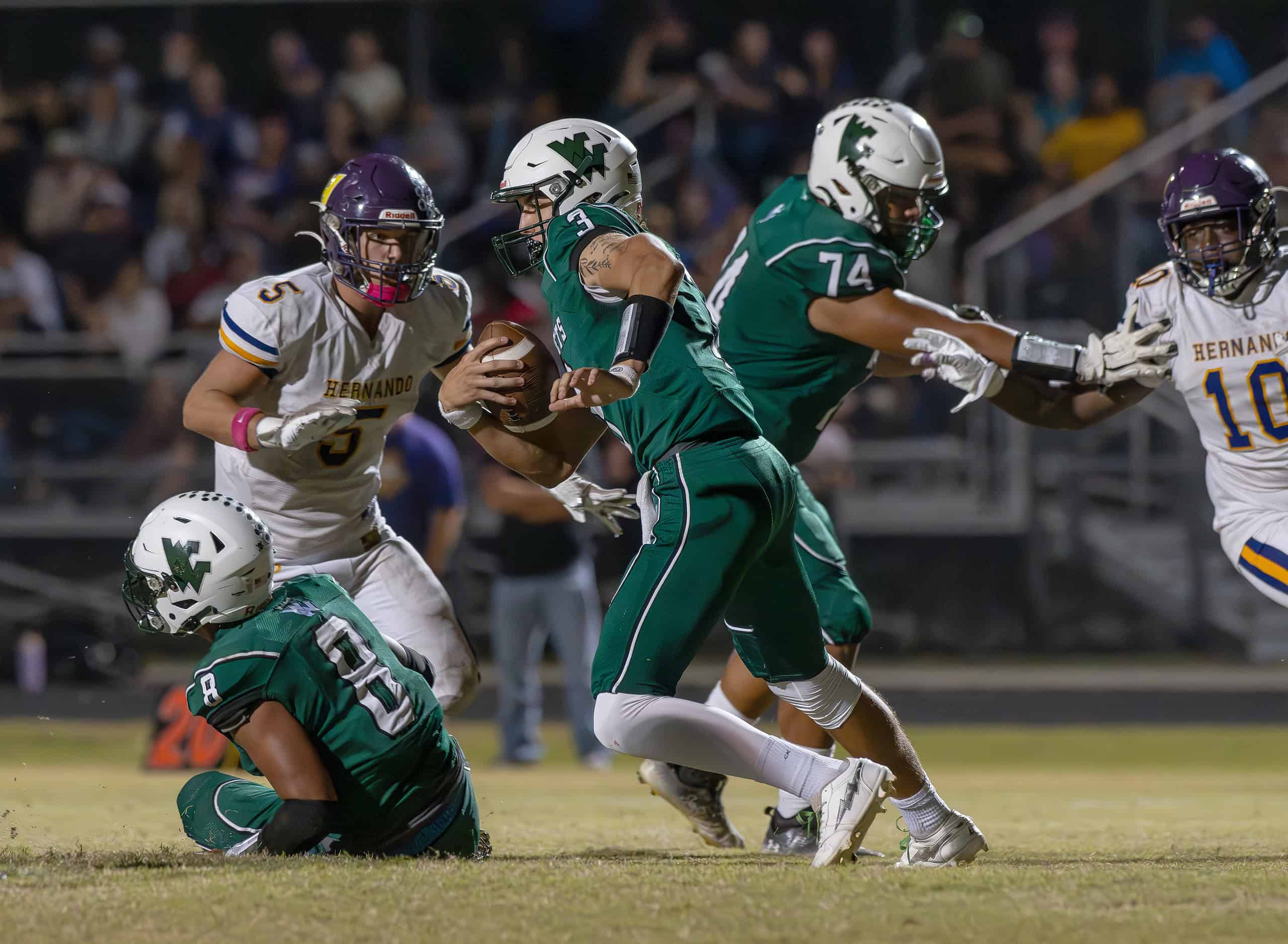 Weeki Wachee High QB, 3, Richard Hanshaw escapes the pocket in the game with visiting Hernando High. [Photo by Joe DiCristofalo]