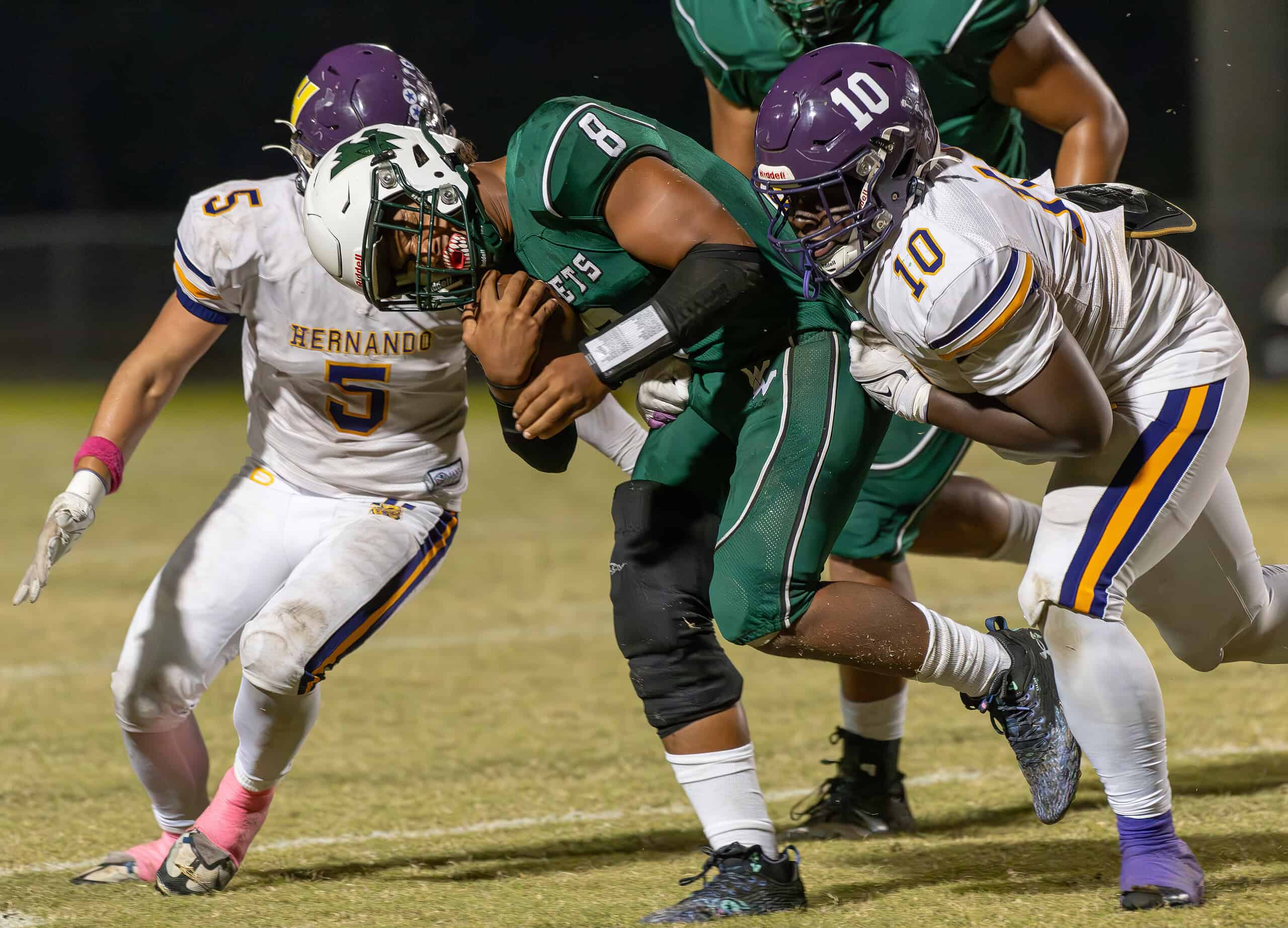 Weeki Wachee High ,8, Leelan Wright has this run stopped by Hernando High defense players 10, Keaundre Gavin and ,5, Sam Jackson. [Photo by Joe DiCristofalo]